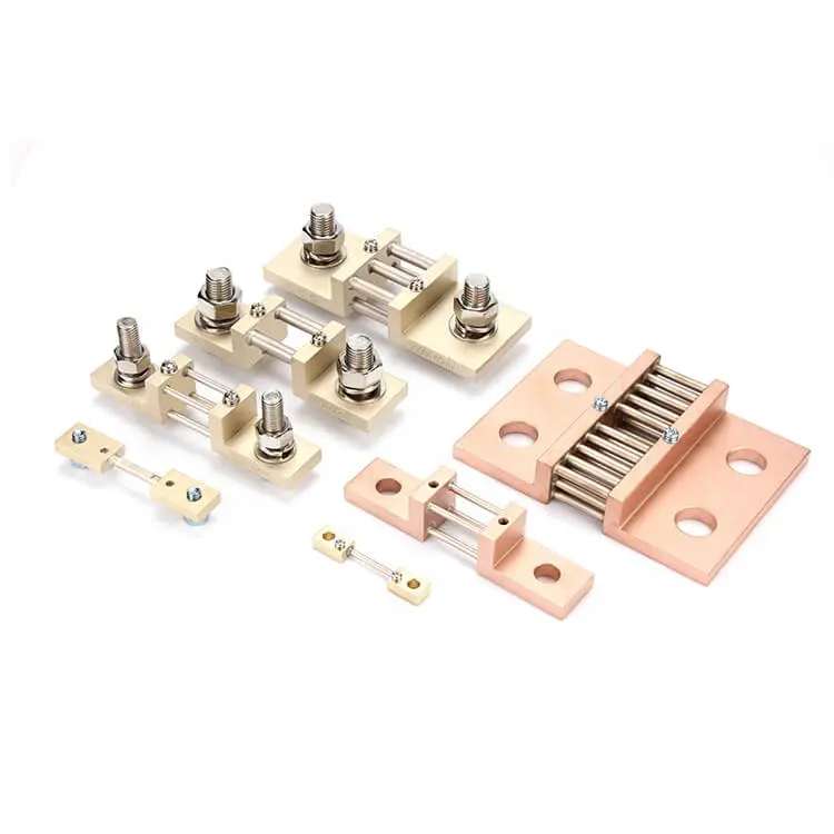 The alternative text for this image could be: "An assortment of DC shunts, which are precision resistors used to measure current flow in ammeters, displayed against a white background. These components vary in size, indicating their different current ratings, and are made of a beige insulating material with metal strips and screws for electrical connections."